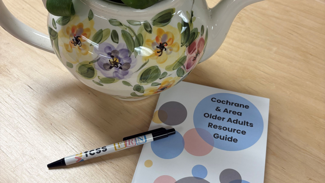 A teapot beside a resource booklet